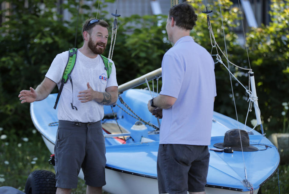 In this Thursday, Aug. 2, 2018 photo, State Rep. Owen Casas, I-Rockport, talks issues with Charlie Strout while campaigning in Camden, Maine. A national group that supports independent political candidates is pouring money into legislative races, raising alarm by critics who say so-called dark money is no longer limited to major political parties. (AP Photo/Robert F. Bukaty)