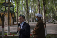 Mamat Juma, left, imam of the Id Kah Mosque, speaks to foreign journalists during a government organized visit at the mosque in Kashgar in western China's Xinjiang Uyghur Autonomous Region on April 19, 2021. Under the weight of official policies, the future of Islam appears precarious in Xinjiang, a remote region facing Central Asia in China's northwest corner. Outside observers say scores of mosques have been demolished, which Beijing denies, and locals say the number of worshippers is on the decline. (AP Photo/Mark Schiefelbein)