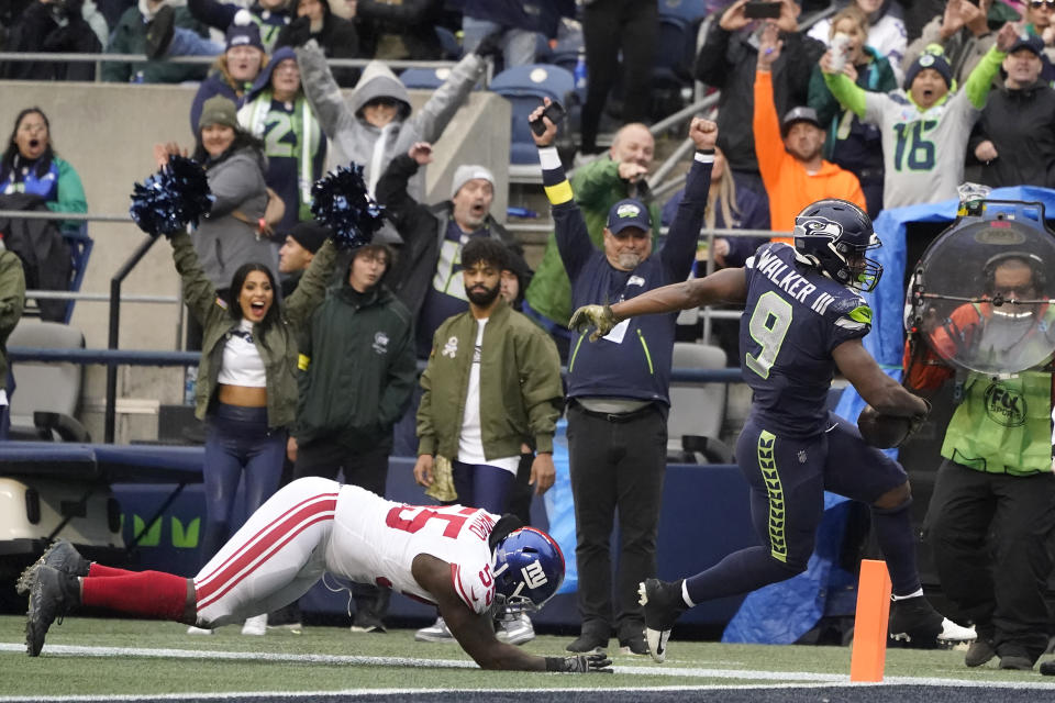 Seattle Seahawks running back Kenneth Walker III (9) scores a touchdown in front of New York Giants linebacker Jihad Ward during the second half of an NFL football game in Seattle, Sunday, Oct. 30, 2022. (AP Photo/Marcio Jose Sanchez)