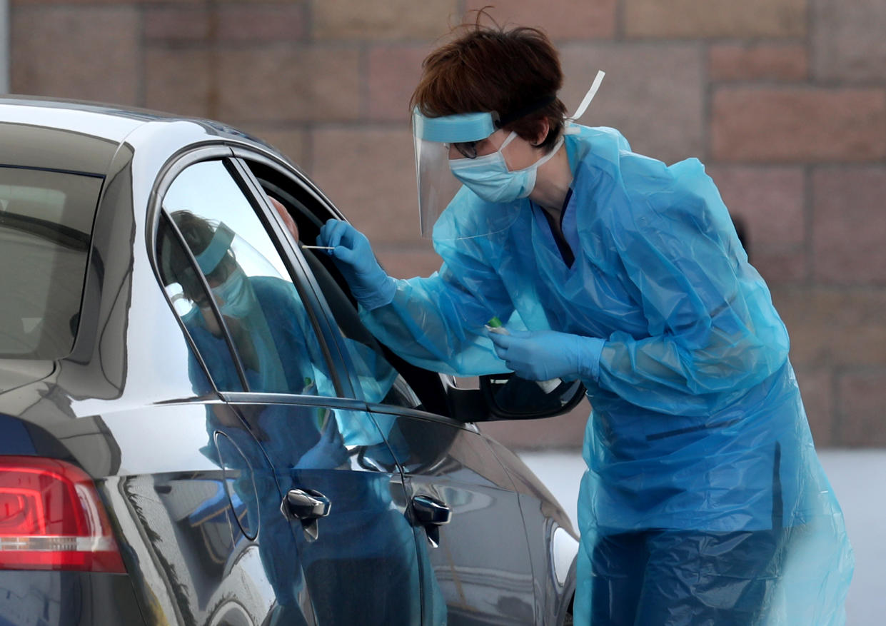 A nurse takes a sample at a COVID 19 testing centre in the car park of the Bowhouse Community Centre in Grangemouth as the UK continues in lockdown to help curb the spread of the coronavirus. (Photo by Andrew Milligan/PA Images via Getty Images)