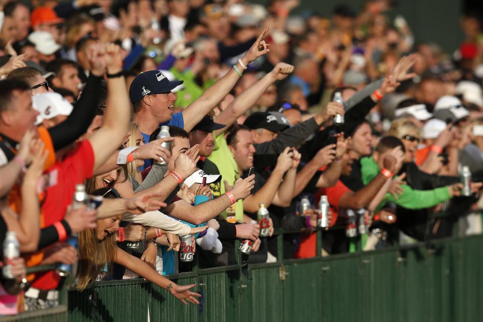 Fans at the 16th hole cheer on Phil Mickelson during the second round of the Phoenix Open golf tournament Friday, Jan. 31, 2014, in Scottsdale, Ariz. (AP Photo/Ross D. Franklin)