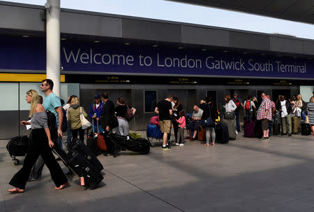 FILE PHOTO: People queue to enter the terminal at Gatwick Airport in southern England, Britain, May 28, 2017. REUTERS/Hannah McKay/File Photo