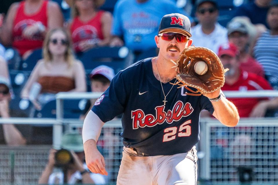 Ole Miss Rebels first baseman Tim Elko (25) catches the ball for an out against the Arkansas Razorbacks during the College World Series at Charles Schwab Field.