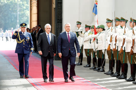 Colombian President Ivan Duque walks alongside his Chilean counterpart Sebastian Pinera during a meeting at La Moneda Palace in Santiago, Chile, March 21, 2019. REUTERS/Rodrigo Garrido