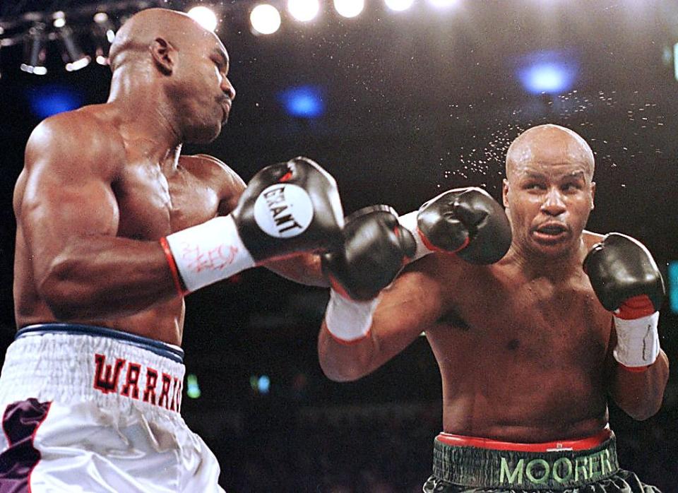 Michael Moorer (R) was 1-1 in two heavyweight title fights with Hall of Famer Evander Holyfield (L). (Getty Images)