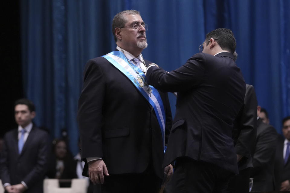 Incoming Guatemalan President Bernardo Arévalo receives the presidential sash during his swearing-in ceremony in Guatemala City, early Monday, Jan. 15, 2024. (AP Photo/Moises Castillo)