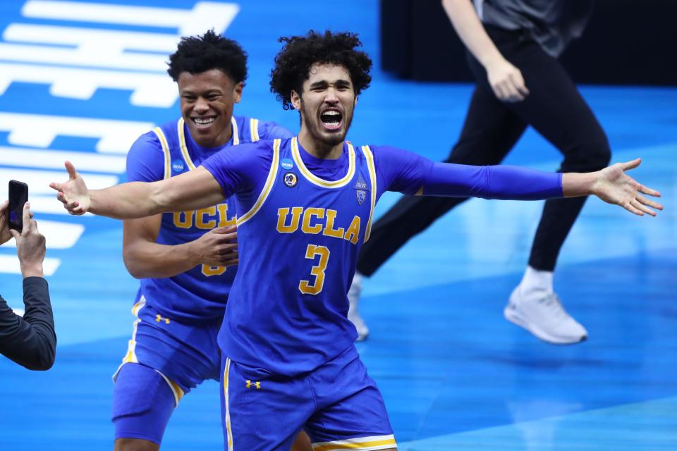 UCLA Bruins guard Johnny Juzang (3) celebrates after defeating the Michigan Wolverines in the Elite Eight of the 2021 NCAA Tournament at Lucas Oil Stadium.