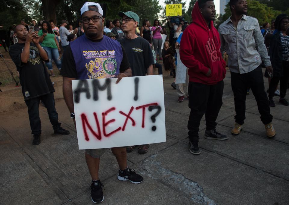 Protesters attend a demonstration against police brutality.&nbsp;