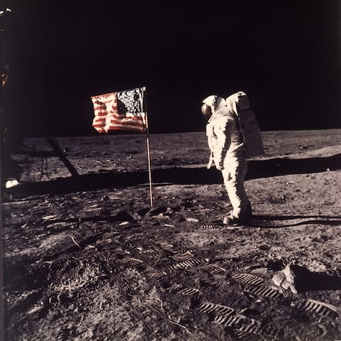 Buzz Aldrin Jr. beside the U.S. flag after man reaches the Moon for the first time during the Apollo 11 mission on July 20, 1969.  - Credit: AP