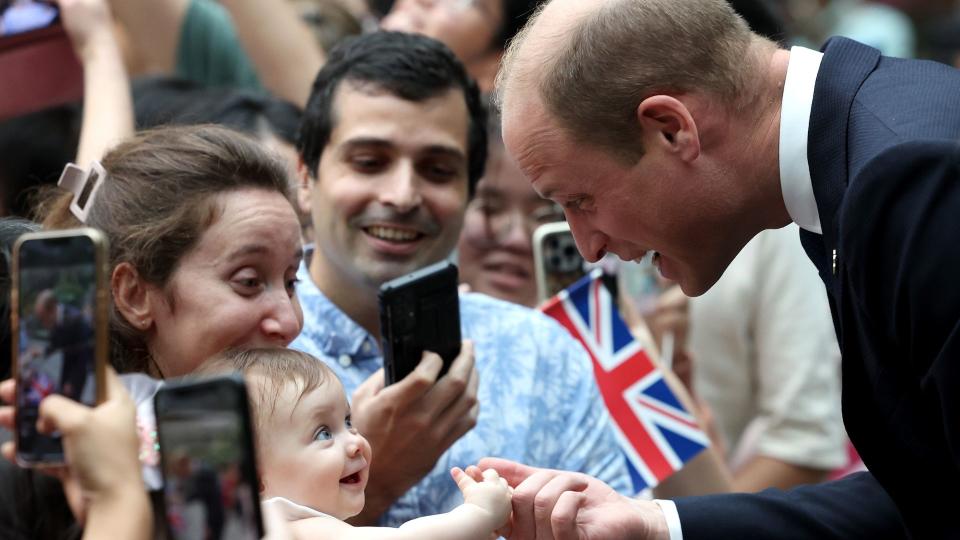 Prince William baby biting his finger