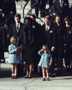 A three-year-old John F. Kennedy Jr. salutes his father's casket in Washington in this Nov. 25, 1963 file photo, three days after the president was assassinated in Dallas. Widow Jacqueline Kennedy, center, and daughter Caroline Kennedy are accompanied by the late president's brothers Sen. Edward Kennedy, left, and Attorney General Robert Kennedy. (AP Photo/File)