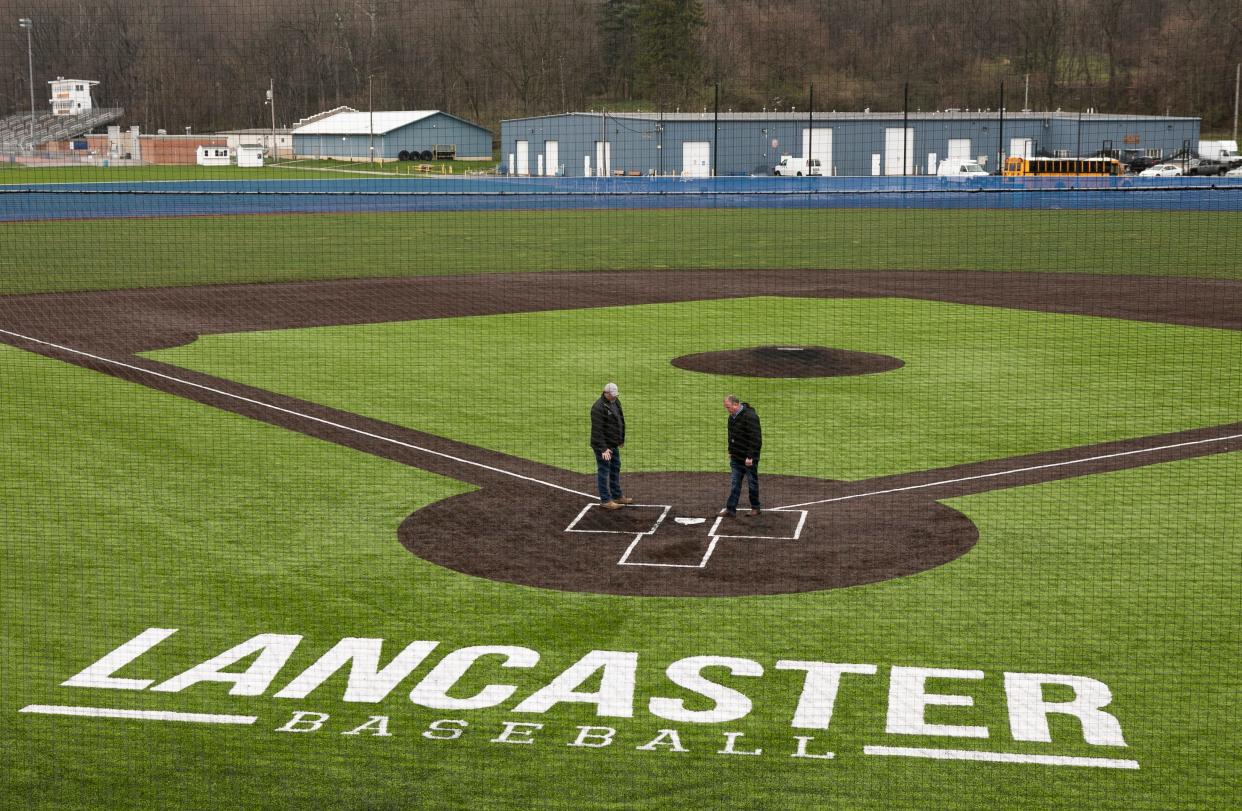 Brad Ward (left), superintendent of Summit Construction, and Jerry Rainey, director of business for Lancaster City Schools, look over the new baseball fields for Lancaster High School on March 31, 2023, in Lancaster, Ohio.