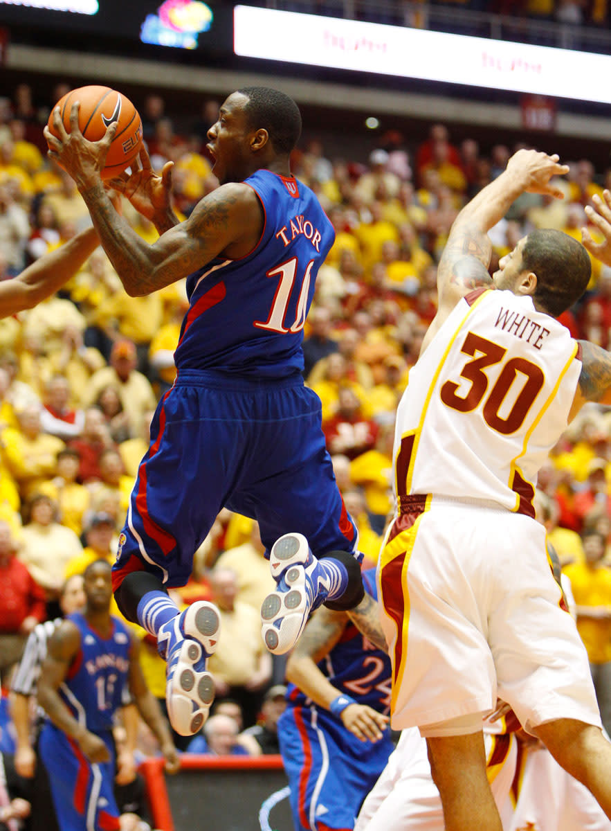 Kansas guard Tyshawn Taylord drives to the basket past Iowa State forward Royce White (30) during second half of an NCAA college basketball game, Saturday, Jan. 28, 2012, in Ames, Iowa. Iowa State won 72-64.