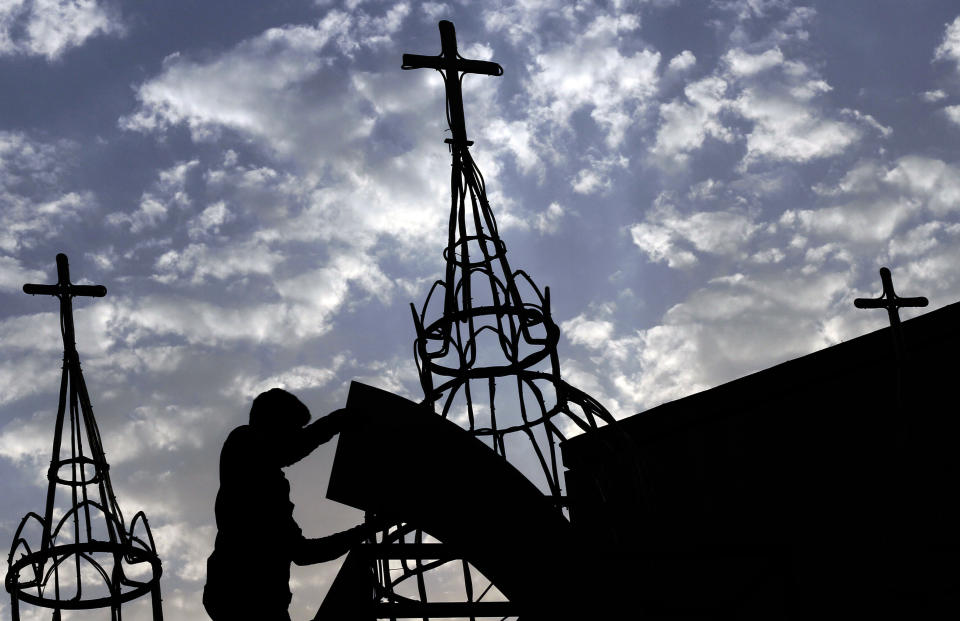 In this Thursday, Aug. 30, 2012 photo, a man works on a construction project at Sacred Heart Church in Manama, Bahrain. When Bahrain announced plans to build the largest Roman Catholic Church in the Gulf, it was accompanied by a noticeable dose of pride to showcase its traditions of religious tolerance. Instead, the planned church has turned into another point of tension in a country already being pulled apart by internal sectarian battles. (AP Photo/Hasan Jamali)