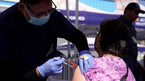 PHOTO: Maria Lopez is given a flu vaccine by nurse Gigi Urcia at the Blue Shield of California Promise Health Plans' Community Resource Center, Oct. 28, 2022, in Lakewood. (Mark J. Terrill/AP)