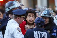 New York Police Department officers detain a protester during a march through the Manhattan borough of New York City calling for social, economic, and racial justice April 29, 2015. Billed as "NYC Rise Up & Shut it Down With Baltimore", the demonstration was being held to support Baltimore's protests against police brutality following the April 19 death of Freddie Gray in police custody. (REUTERS/Mike Segar)