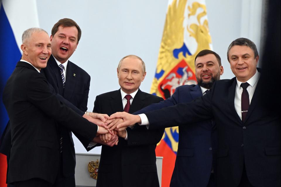 FILE - From left, Moscow-appointed head of Kherson Region Vladimir Saldo, Moscow-appointed head of Zaporizhzhia region Yevgeny Balitsky, Russian President Vladimir Putin, center, Denis Pushilin, leader of self-proclaimed of the Donetsk People's Republic and Leonid Pasechnik, leader of self-proclaimed Luhansk People's Republic pose for a photo during a ceremony to sign the treaties for four regions of Ukraine to join Russia, at the Kremlin in Moscow, on Sept. 30, 2022. (Grigory Sysoyev, Sputnik, Kremlin Pool Photo via AP, File)