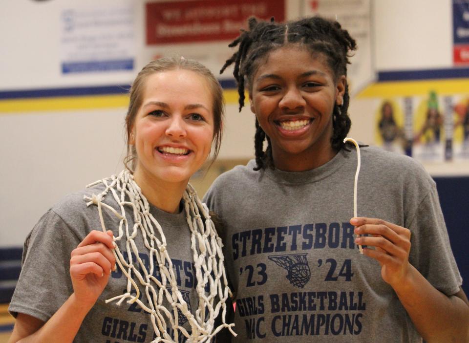 Streetsboro's Ella Kassan, left, and Naomi Benson after cutting down the nets.