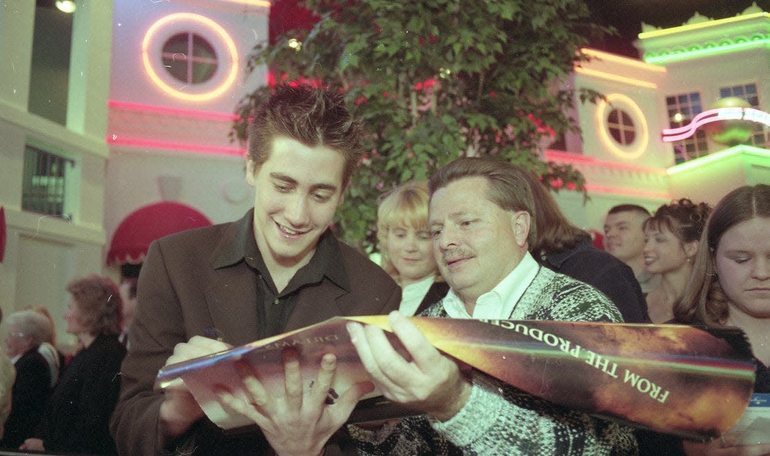 Actor Jake Gyllenhaal, left, signs an autograph for Anderson County Commissioner Wimp Shoopman, right before the Southern premiere of the Universal Pictures film 'October Sky'  at Regal Cinemas West Town Mall 9, Feb. 16, 1999.