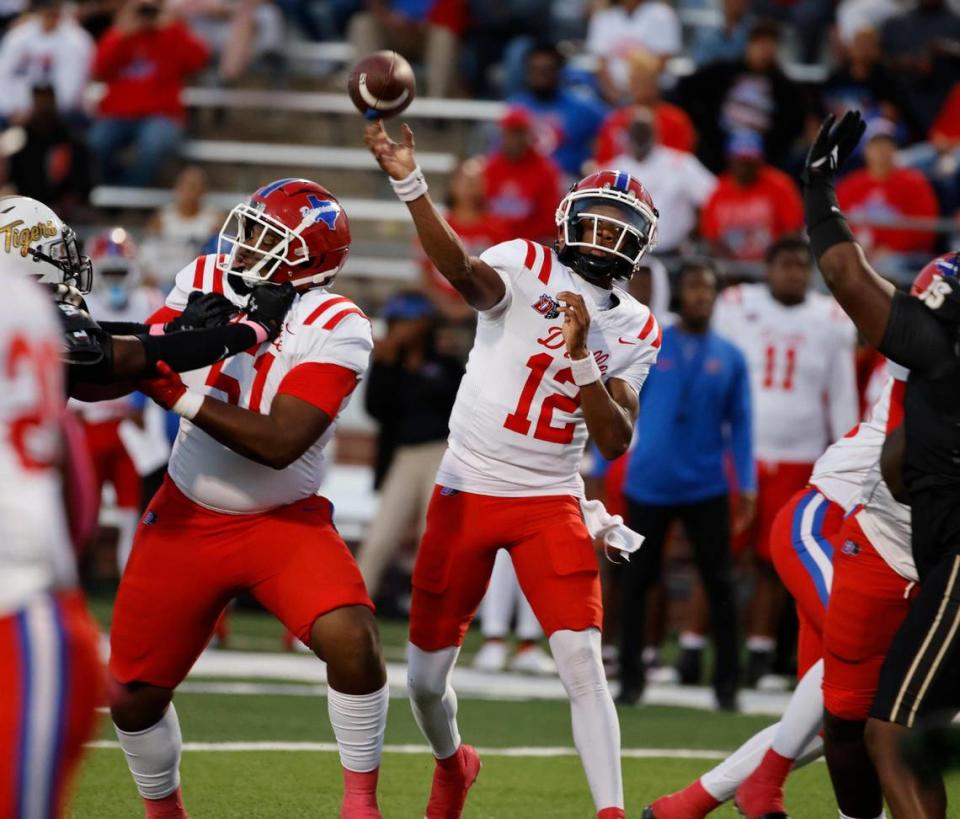 Duncanville quarterback Keelon Russell (12) throws the first touchdown pass of the game in the first half of a UIL high school football game at Vernon Newsom Stadium in Mansfield, Texas, Thursday, Oct. 12, 2023.