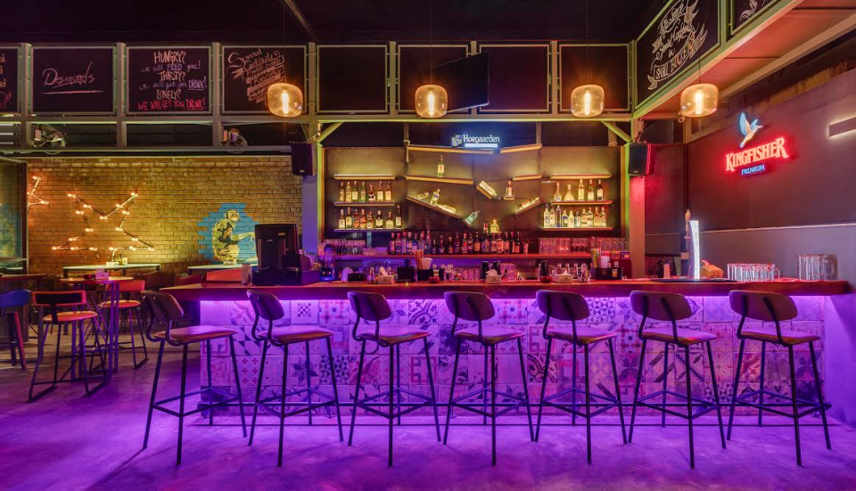 Bar on the first floor with a good mix of elements - bottles, wood and coloured lights.  