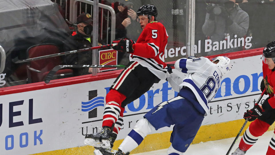 Mar 7, 2021; Chicago, Illinois, USA; Chicago Blackhawks defenseman Connor Murphy (5) checks Tampa Bay Lightning defenseman Erik Cernak (81) during the second period at the United Center. Murphy received a match misconduct penalty on the play. Mandatory Credit: Dennis Wierzbicki-USA TODAY Sports - 15688877