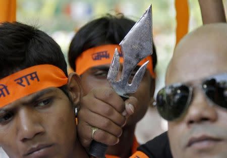 A file photo of members from hardline Hindu groups holding a trident during a protest in New Delhi May 9, 2011. REUTERS/B Mathur/Files