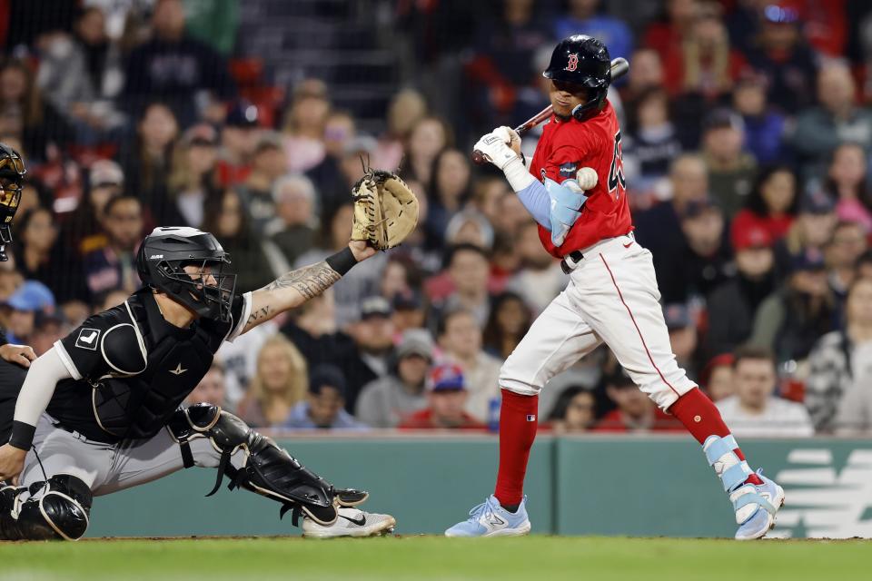 Boston Red Sox's Ceddanne Rafaela, right, is hit by a pitch in front of Chicago White Sox catcher Korey Lee during the eighth inning of a baseball game, Friday, Sept. 22, 2023, in Boston. (AP Photo/Michael Dwyer)