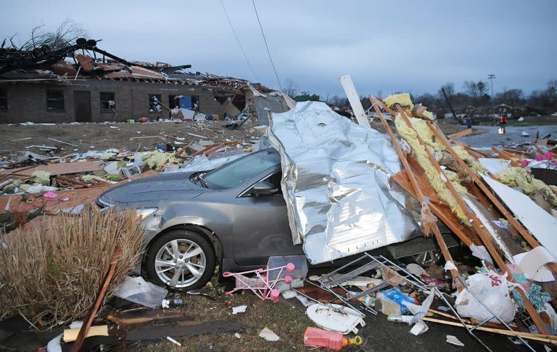 Debris covers a car near after a tornado touched down at Donelson Christian Academy in Nashville