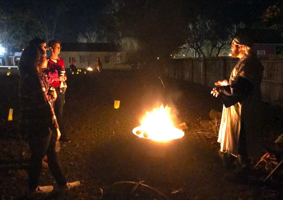 Visitors visit the campfire of Joseph, a lowly carpenter from Nazareth, played by Kyle Lusk, during Laurel Hill Presbyterian Church's Living Nativity Dec. 12.