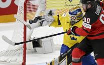 Goalkeeper Linus Ullmark of Sweden, left, and Pierre-Luc Dubois of Canada vie during the Hockey World Championship quarterfinal match between Sweden and Canada in Tampere, Finland, Thursday, May 26, 2022. (Vesa Moilanen/Lehtikuva via AP)