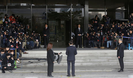 South Korea's former president Lee Myung-bak (C) speaks as he arrives at the prosecutors' office in Seoul, South Korea, March 14, 2018. Ahn Young-joon/Pool via Reuters