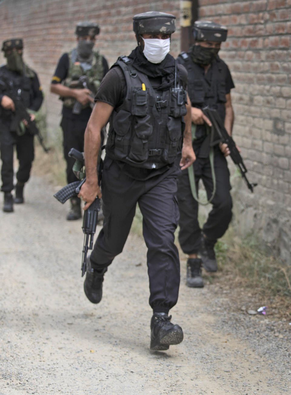 Members of Special Operations Group (SOG) of Jammu and Kashmir police arrive at the site of an attack on policemen on the outskirts of Srinagar, Indian controlled Kashmir, Friday, Aug. 14, 2020. Anti-India rebels in Indian-controlled Kashmir Friday attacked a police party in the disputed region's main city, killing two police officials and injuring another, police said. (AP Photo/Mukhtar Khan)