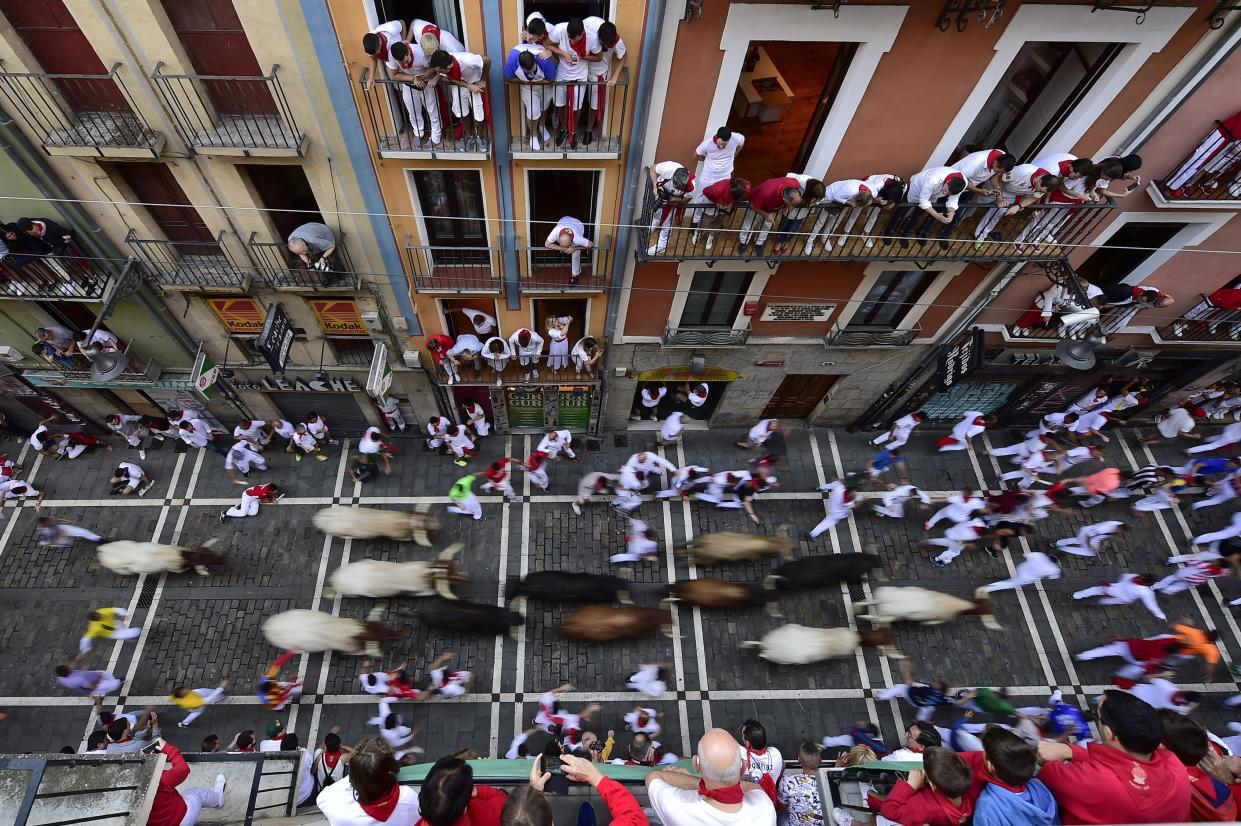 Revellers run next to fighting bulls during the running of the bulls at the San Fermin Festival, in Pamplona, northern Spain, Friday, July 12, 2019. (Photo: Alvaro Barrientos/AP)