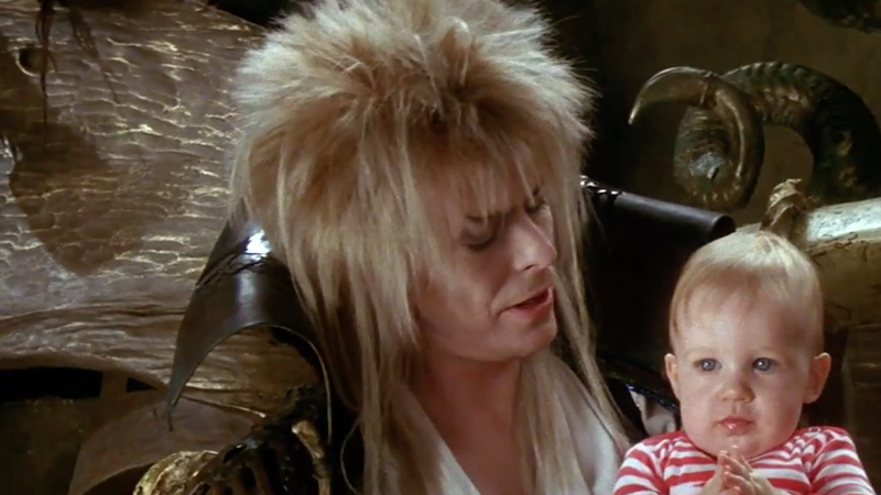 david bowie, as jareth the goblin king, holds baby toby in a scene from labyrinth a good housekeeping pick for best halloween movies for kids