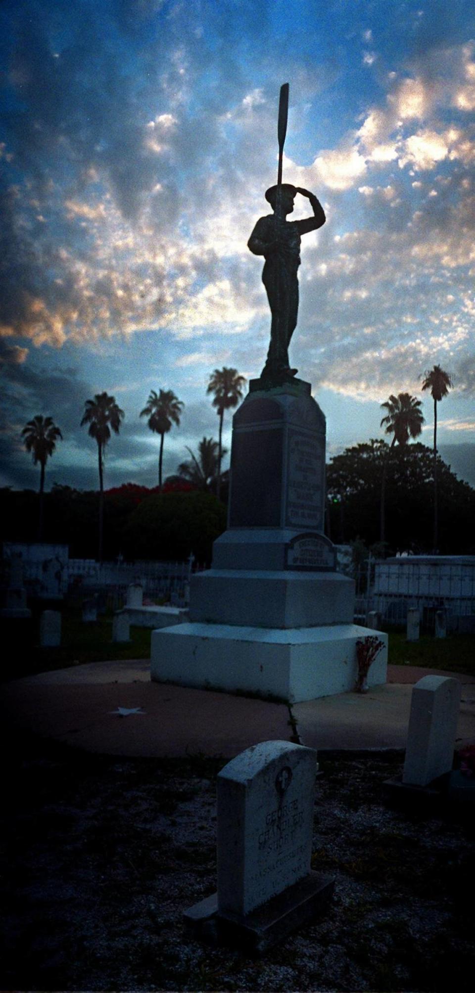 The sun sets on the tiny plot where a statue has been erected in memory of the 266 victims of the Maine tragedy. Carl Juste/Miami Herald File/1997