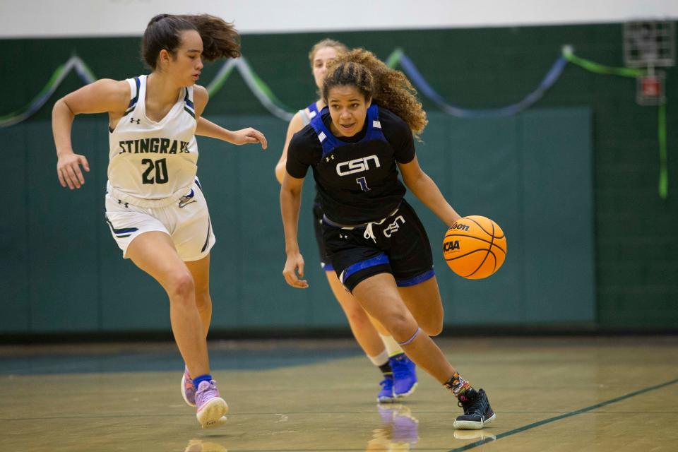 Community School of Naples' Kiara Cabrera (1) drives against Seacrest Country Day's Madison D'Elia (20) during the second half of the high school varsity girls basketball game between Community School of Naples and Seacrest Country Day, Friday, Jan. 7, 2022, at Seacrest Country Day School in Naples, Fla.Community School of Naples defeated Seacrest Country Day 61-51.