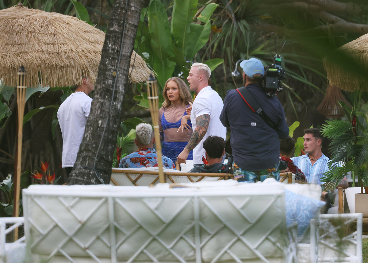 A tall bleach blonde contestant arguing with another man while filming FBOY Island.