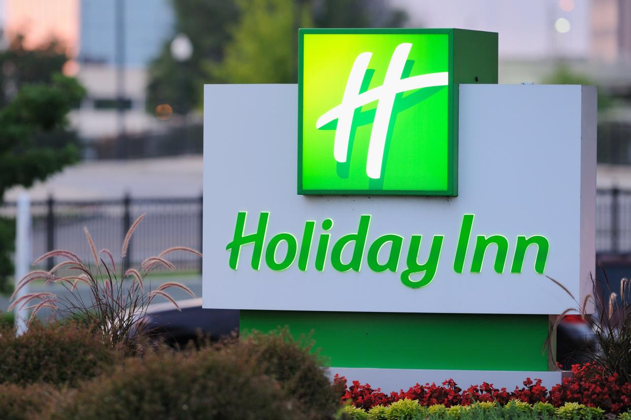 illuminated Holiday Inn sign at dusk