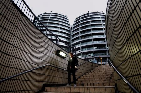 A man walks down a flight of stairs near buildings surrounding the Old Street roundabout, dubbed "Silicon Roundabout", in London, in this May 28, 2013 file photo. REUTERS/Luke Macgregor/Files