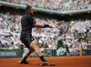 Jo-Wilfried Tsonga of France returns the ball to Kei Nishikori of Japan during their men's quarter-final match during the French Open tennis tournament at the Roland Garros stadium in Paris, France, June 2, 2015. REUTERS/Jean-Paul Pelissier