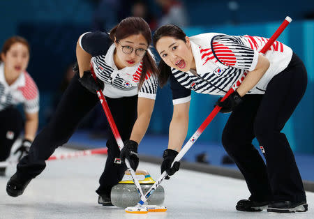 FILE PHOTO: Curling - Pyeongchang 2018 Winter Olympics - Women’s Round Robin - Canada v South Korea - Gangneung Curling Center - Gangneung, South Korea - February 15, 2018 - Kim Kyeong-ae and Kim Seo-yeong of South Korea sweep. REUTERS/Cathal McNaughton/File Photo
