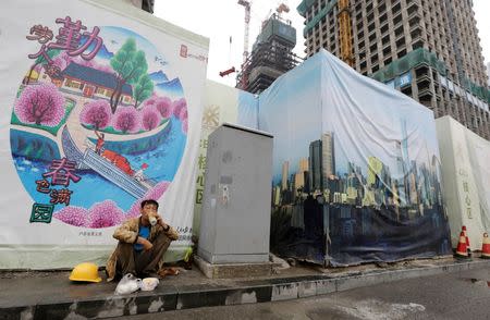 A worker eats his lunch outside a construction site in Beijing's central business district, China, July 15, 2016. REUTERS/Jason Lee