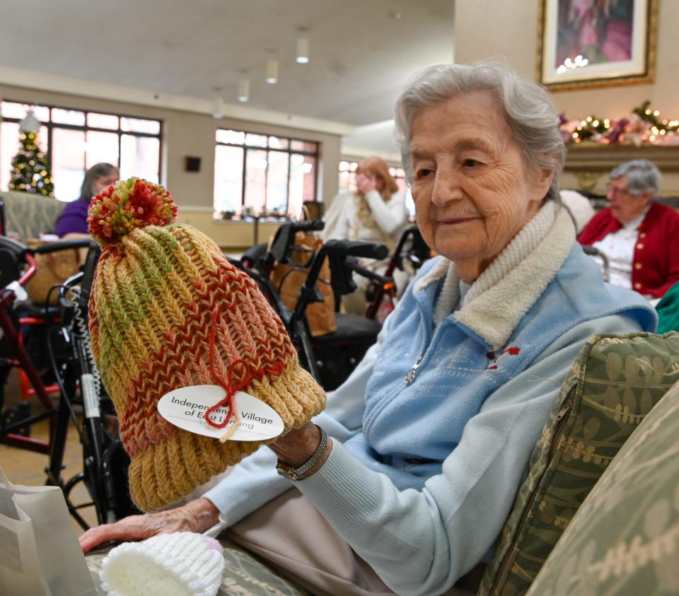 Sandra Galasso shows off a knitted hat from the Independence Village Knitting Group on Thursday, Dec. 15, 2022.