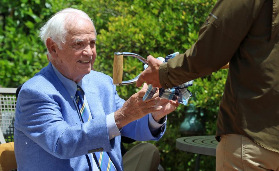 Bill Williamson is presented a shovel during the Thank You celebration for naming of the William H. Williamson III Orchid Conservatory held Thursday, May 12, 2022, at Daniel Stowe Botanical Garden.