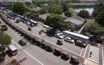 Motorists queue up to buy gasoline near a fuel station in Colombo, Sri Lanka, Thursday, May 19, 2022. (AP Photo/Eranga Jayawardena)