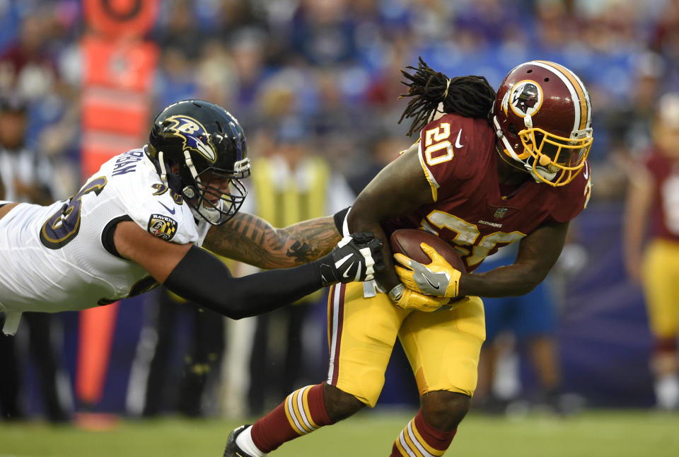 Nicely done: Washington RB Rob Kelley and teammate Keith Marshall performed a random act of kindness this week. (AP)