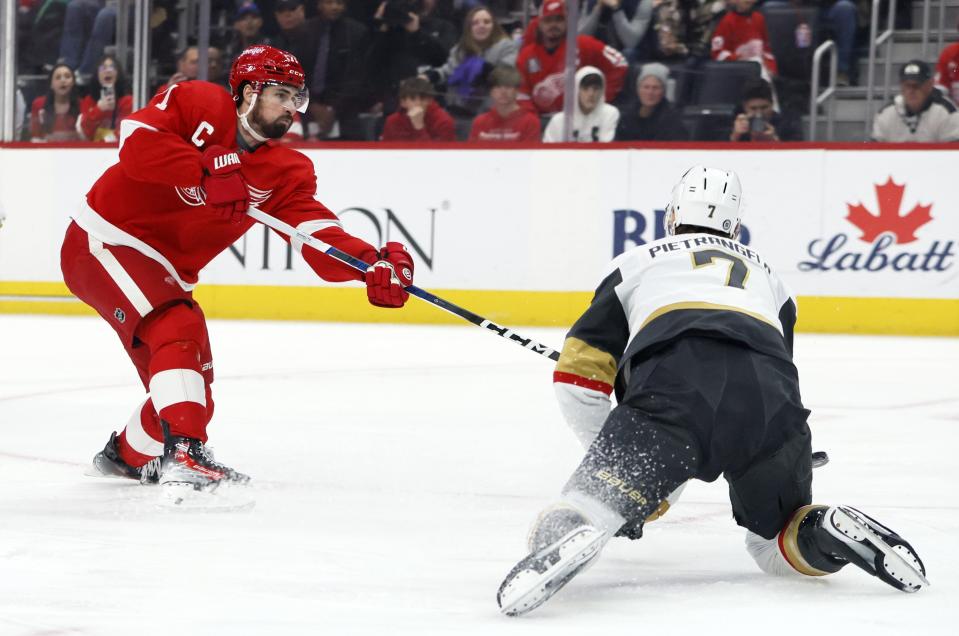 Detroit Red Wings center Dylan Larkin (71) shoots the puck past Vegas Vegas Golden Knights defenseman Alex Pietrangelo (7) to score during the first period of an NHL hockey game Saturday, Jan. 27, 2024, in Detroit. (AP Photo/Duane Burleson)