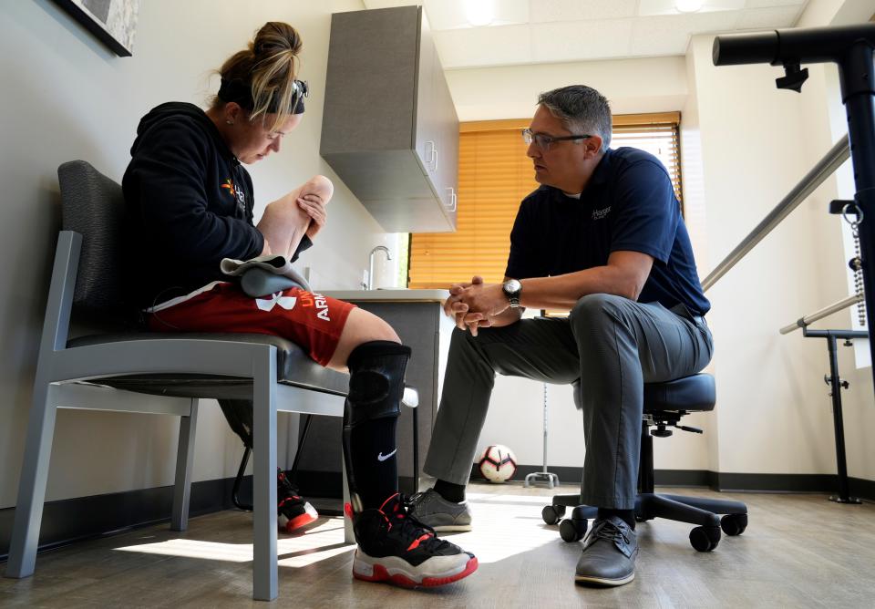 Katie Bondy consults with Jason Macedonia, a prosthetist and orthotist at the Hanger Clinic, during a prosthetic and orthotic fitting appointment. Bondy, a 32-year-old science teacher in the Hilliard district, is part of the U.S. Women's National Amputee Soccer Team that will compete in the Amp Futbol Cup in Warsaw, Poland.