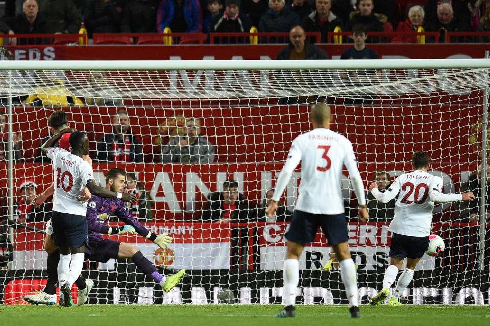 Liverpool's English midfielder Adam Lallana (R) scores their first goal during the English Premier League football match between Manchester United and Liverpool at Old Trafford in Manchester, north west England, on October 20, 2019. (Photo by Oli SCARFF / AFP) / RESTRICTED TO EDITORIAL USE. No use with unauthorized audio, video, data, fixture lists, club/league logos or 'live' services. Online in-match use limited to 120 images. An additional 40 images may be used in extra time. No video emulation. Social media in-match use limited to 120 images. An additional 40 images may be used in extra time. No use in betting publications, games or single club/league/player publications. /  (Photo by OLI SCARFF/AFP via Getty Images)